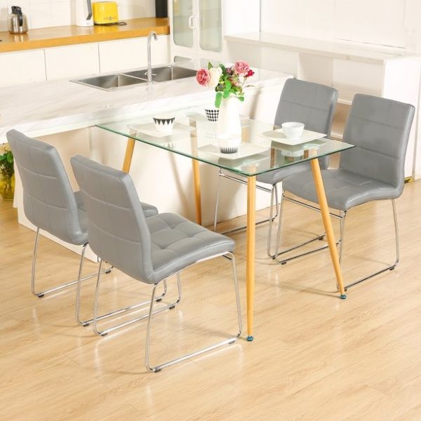 میز ناهارخوری چهارنفره شیشه ای با صندلی های چرمی فلزی